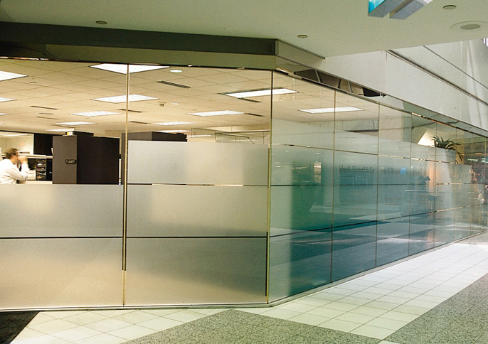 Modern hallway with frosted decorative window film on glass partitions creating privacy and visual interest