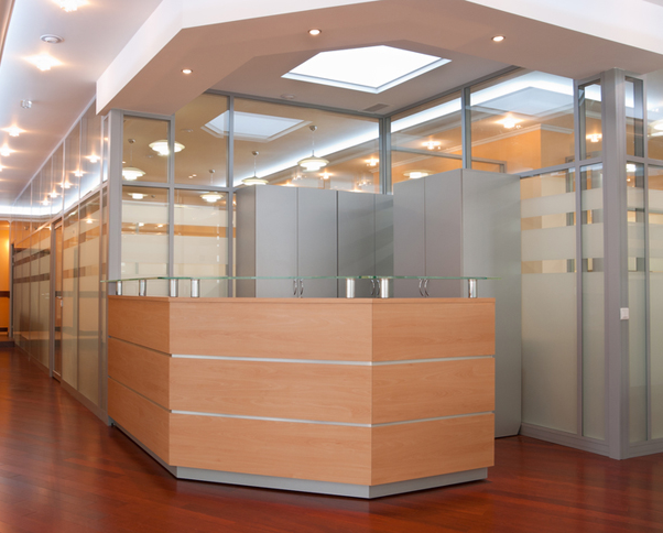 Modern office lobby with decorative frosted glass partitions and design film creating professional environment