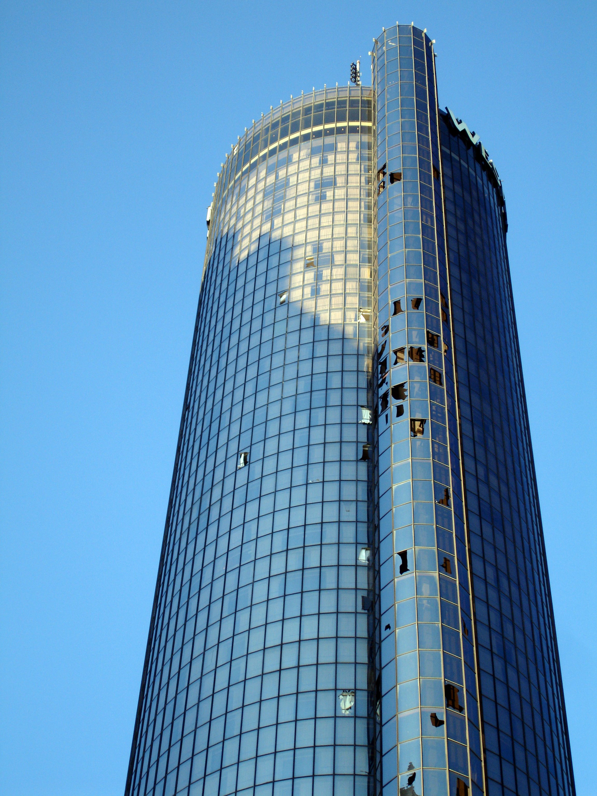 Skyscraper with storm damaged windows showing need for GlassLock storm protection film